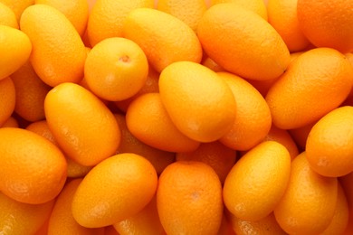 Photo of Many fresh ripe kumquats as background, closeup