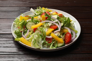 Tasty fresh vegetarian salad on dark wooden table, closeup