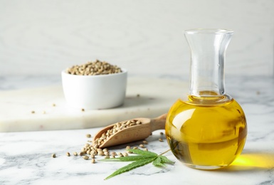 Photo of Composition with hemp oil on marble table