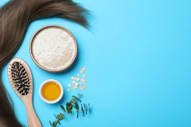 Flat lay composition with homemade hair mask and ingredients on light blue background. Space for text