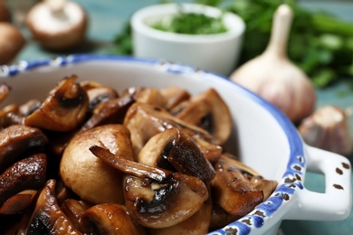 Dish of tasty fried mushrooms, closeup view