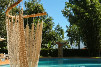 Hammock near pool with clean water outdoors, closeup