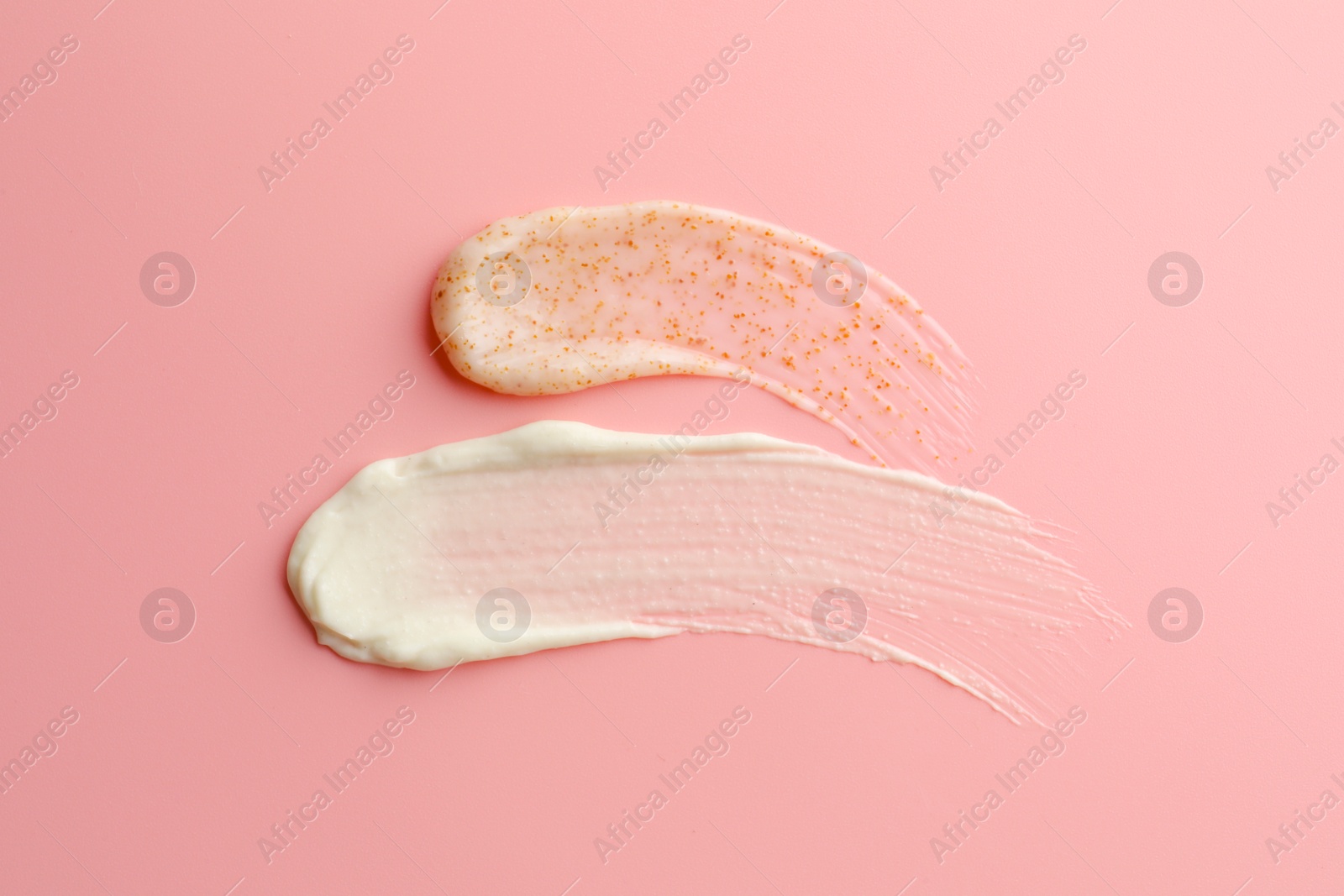 Photo of Samples of scrubs on pink background, top view