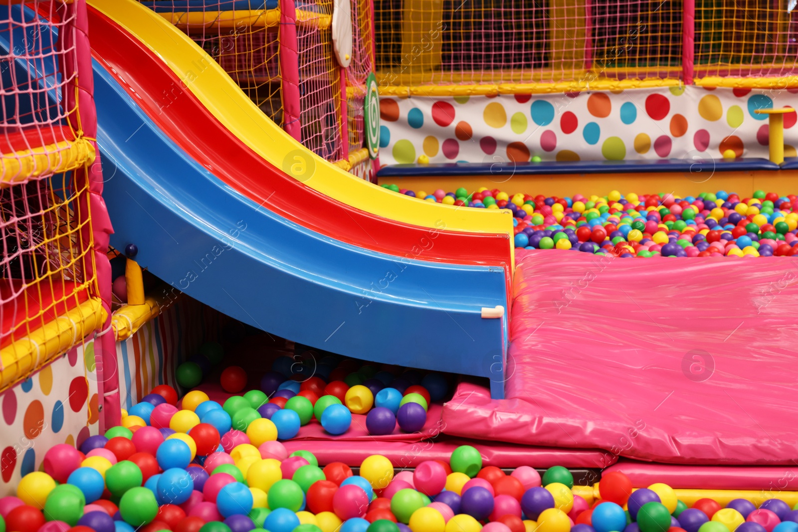 Photo of Slides and many colorful balls in ball pit