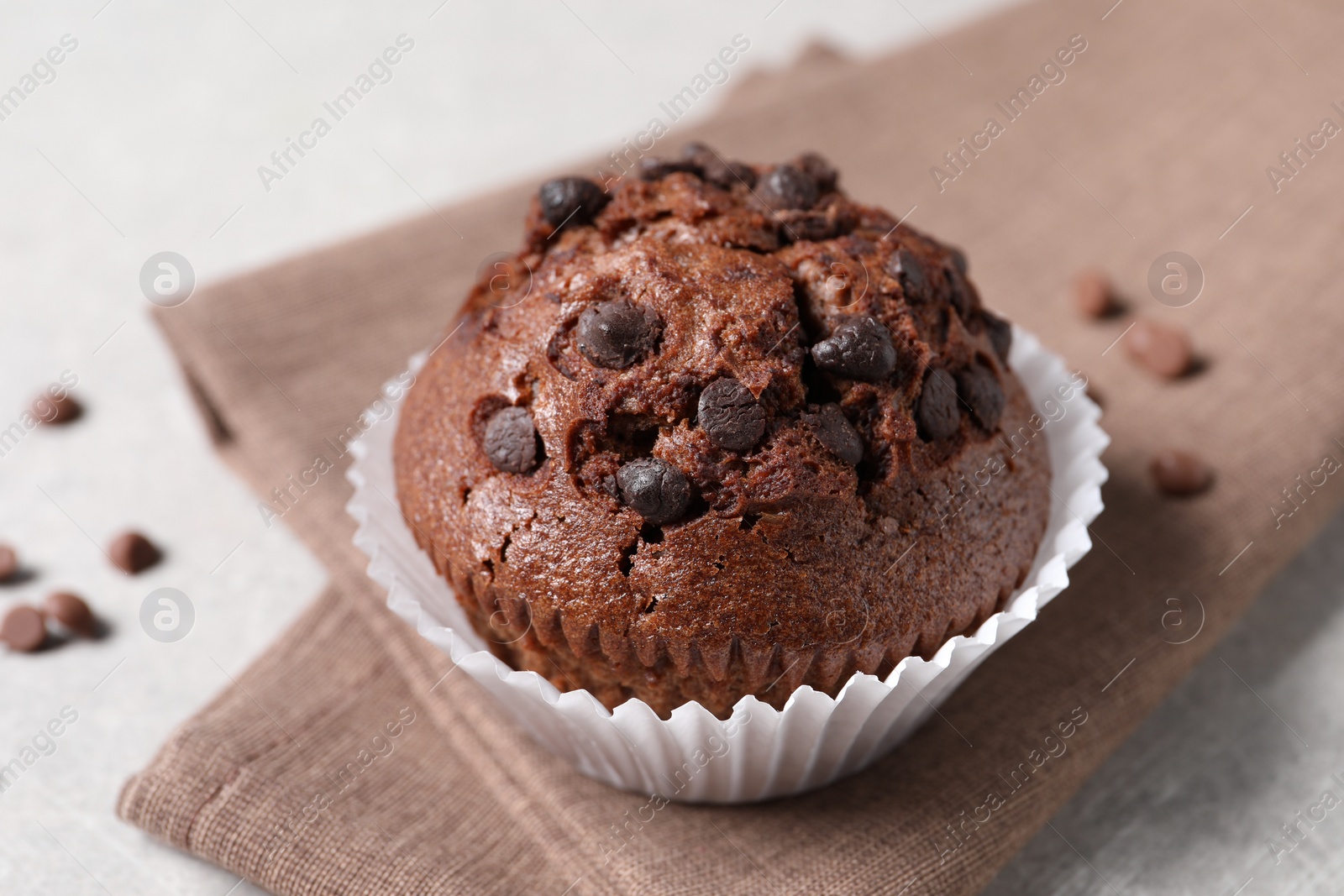 Photo of Tasty chocolate muffin on grey table, closeup