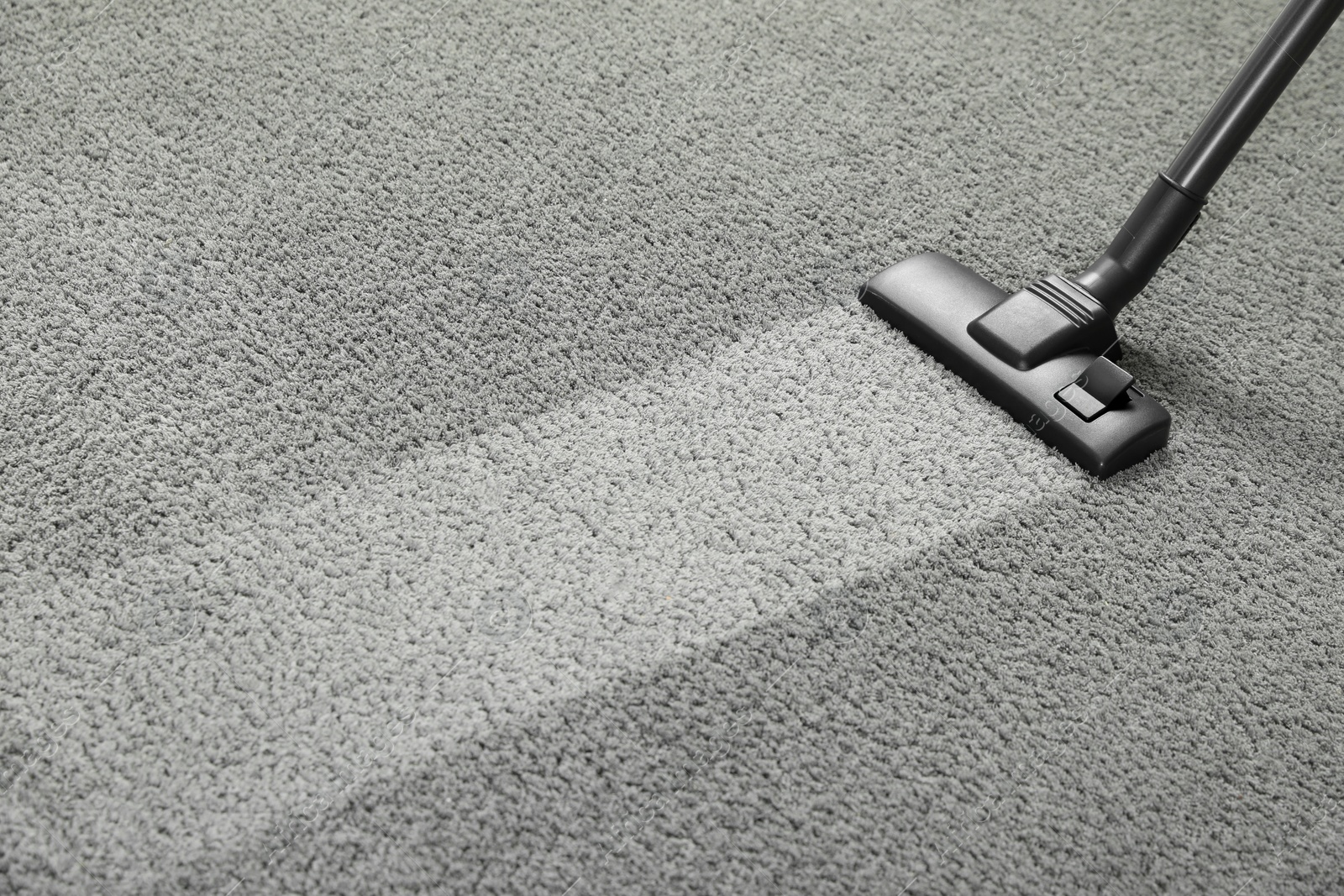 Photo of Vacuuming grey carpet. Clean area after using device. Space for text