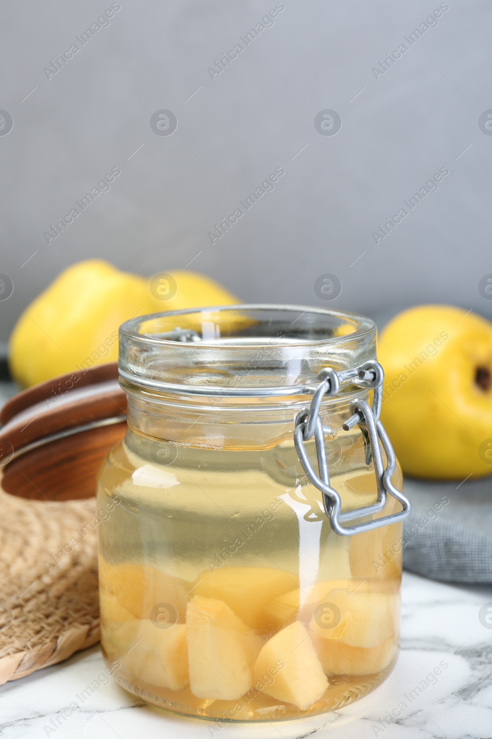 Photo of Delicious quince drink in jar on table
