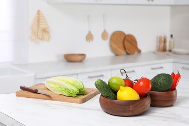 Fresh ripe vegetables and fruits on table in kitchen, space for text
