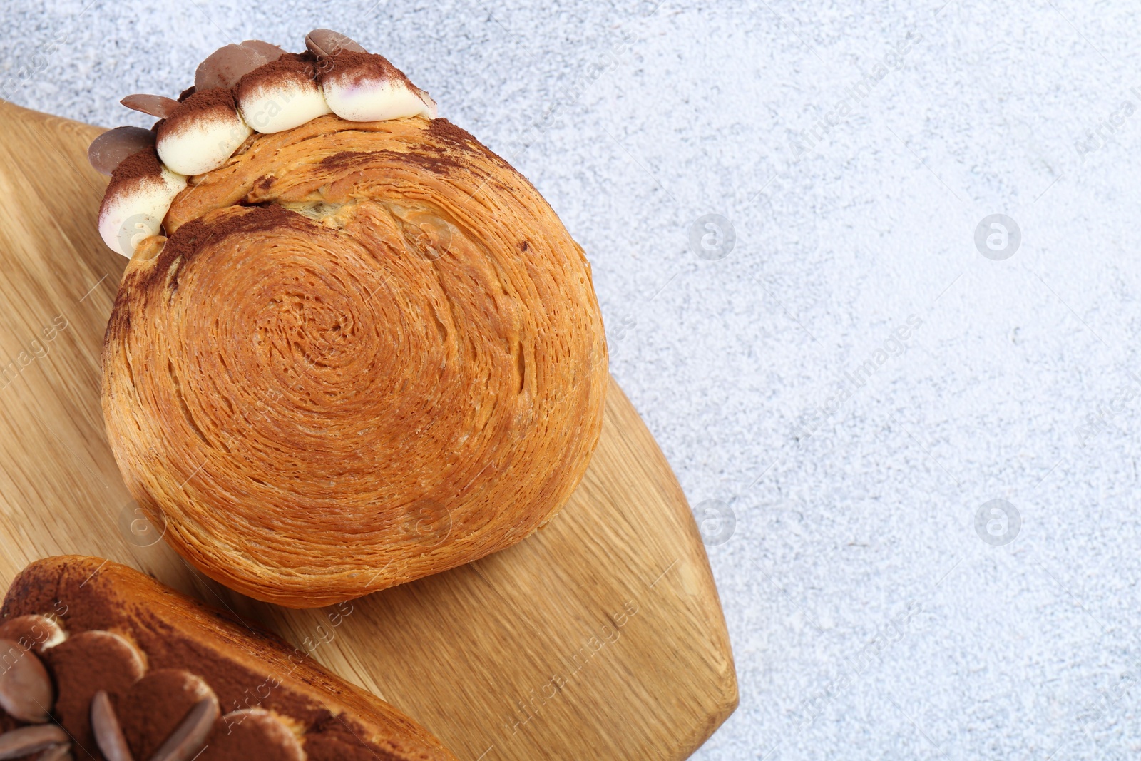 Photo of Tasty puff pastry. Supreme croissants with chocolate chips and cream on grey table, top view. Space for text