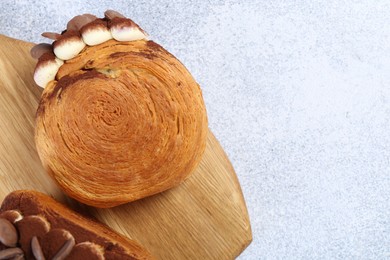 Photo of Tasty puff pastry. Supreme croissants with chocolate chips and cream on grey table, top view. Space for text