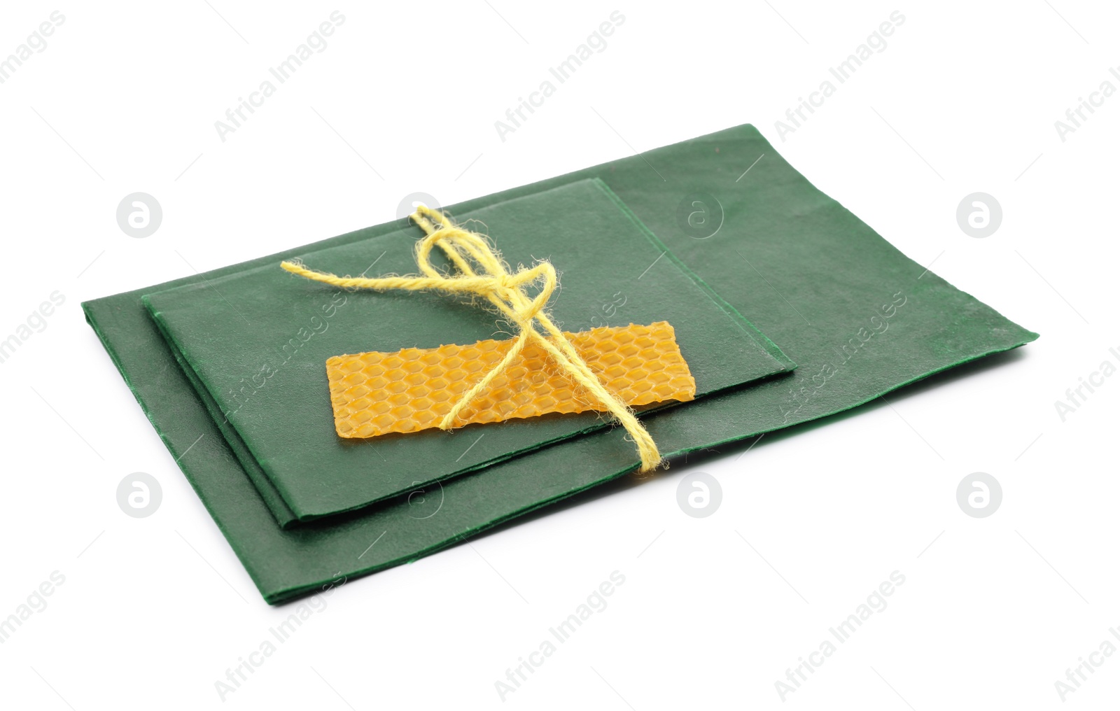 Photo of Reusable beeswax food wraps on white background