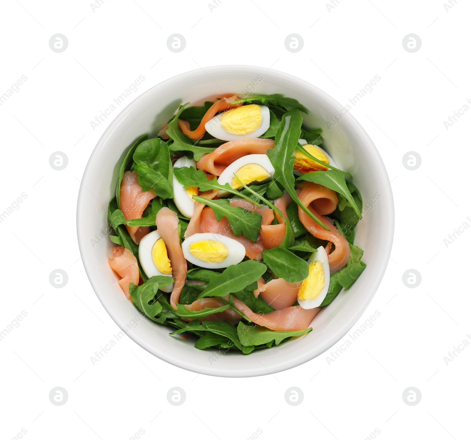 Photo of Delicious salad with boiled eggs, salmon and arugula in bowl isolated on white, top view