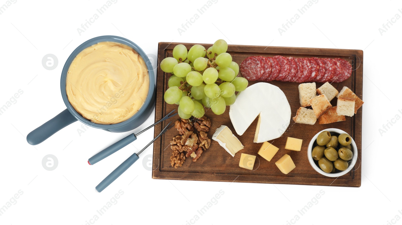 Photo of Fondue with tasty melted cheese, forks and different snacks isolated on white, top view