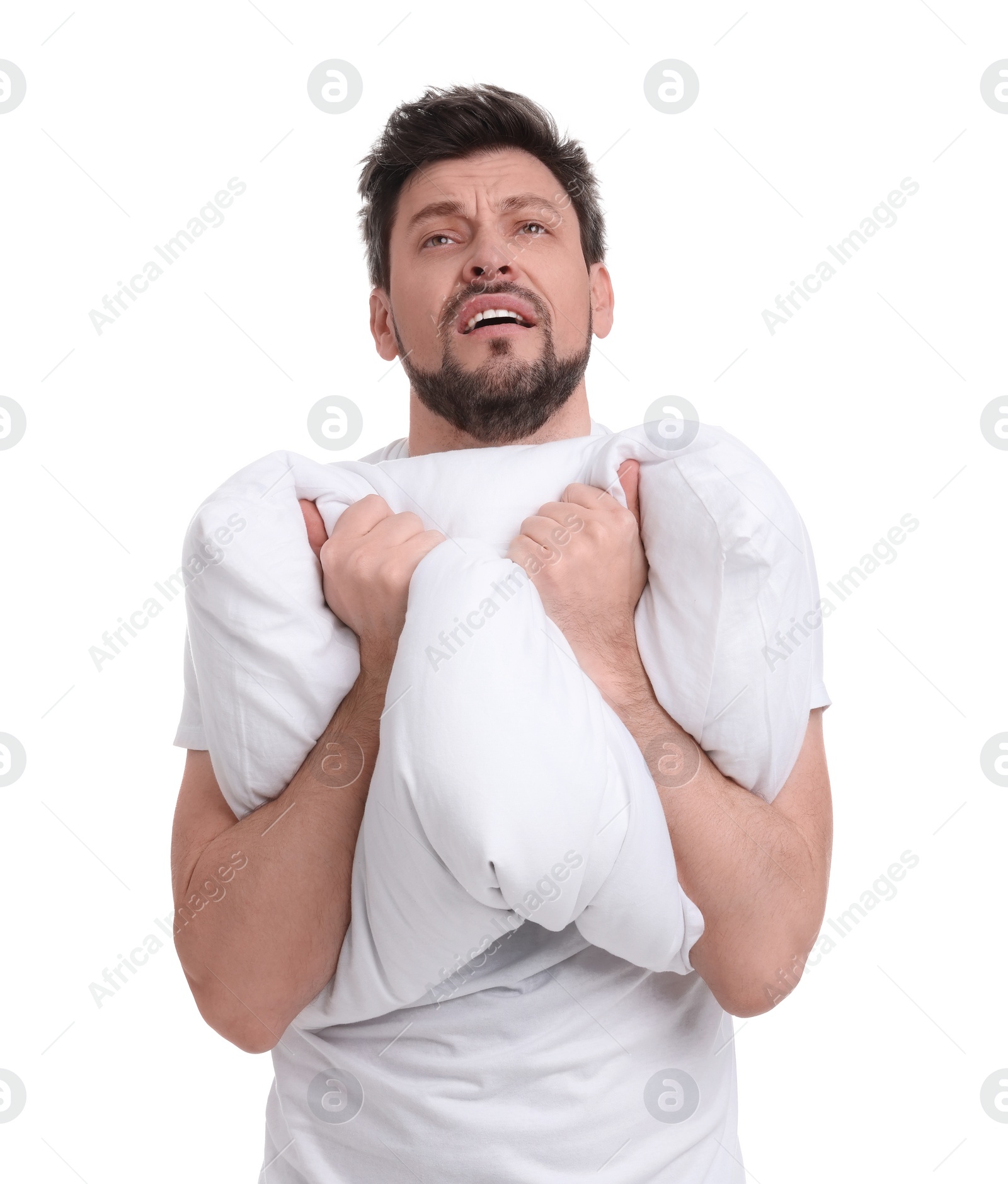 Photo of Tired man with pillow on white background. Insomnia problem