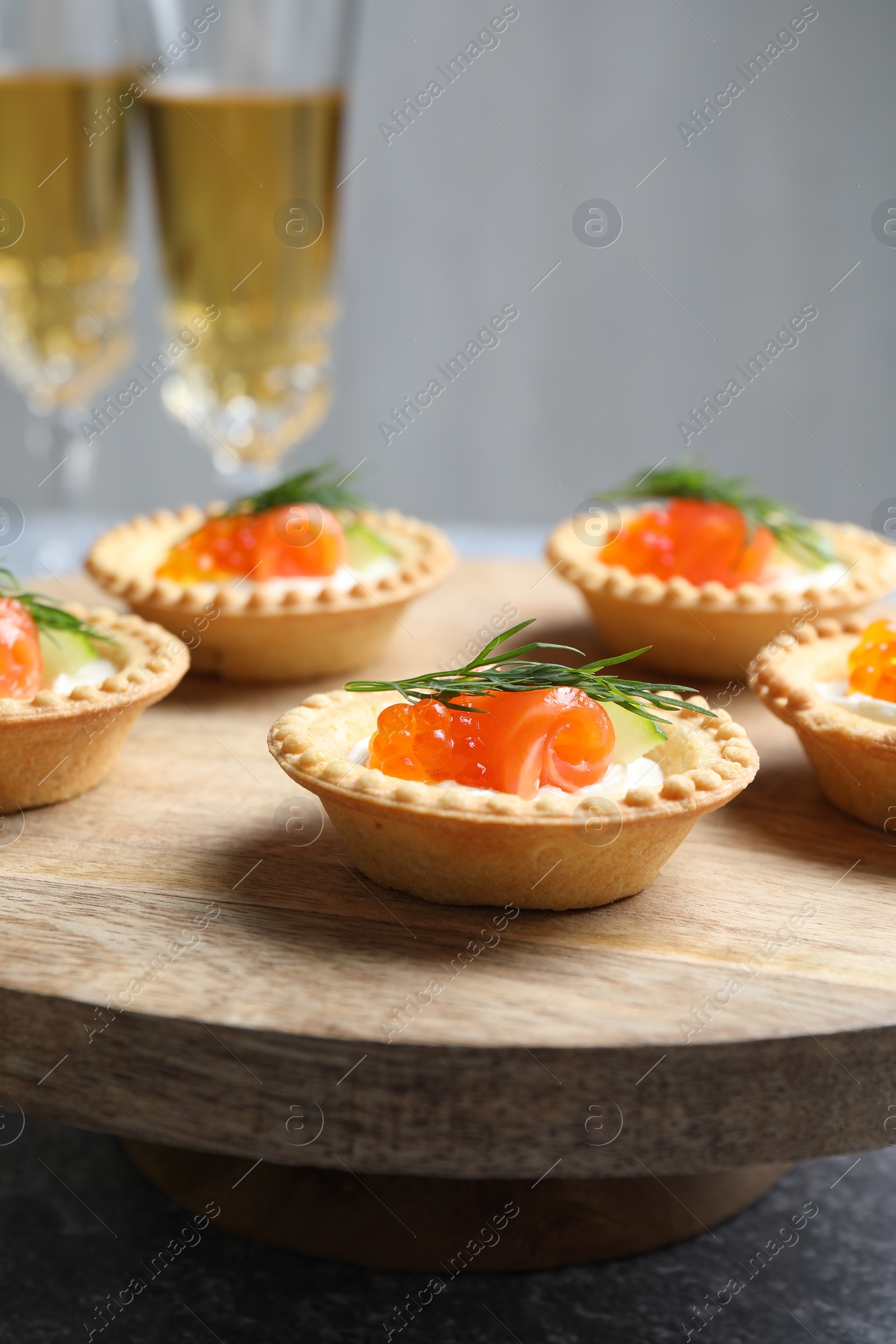 Photo of Delicious canapes with salmon and red caviar on table, closeup