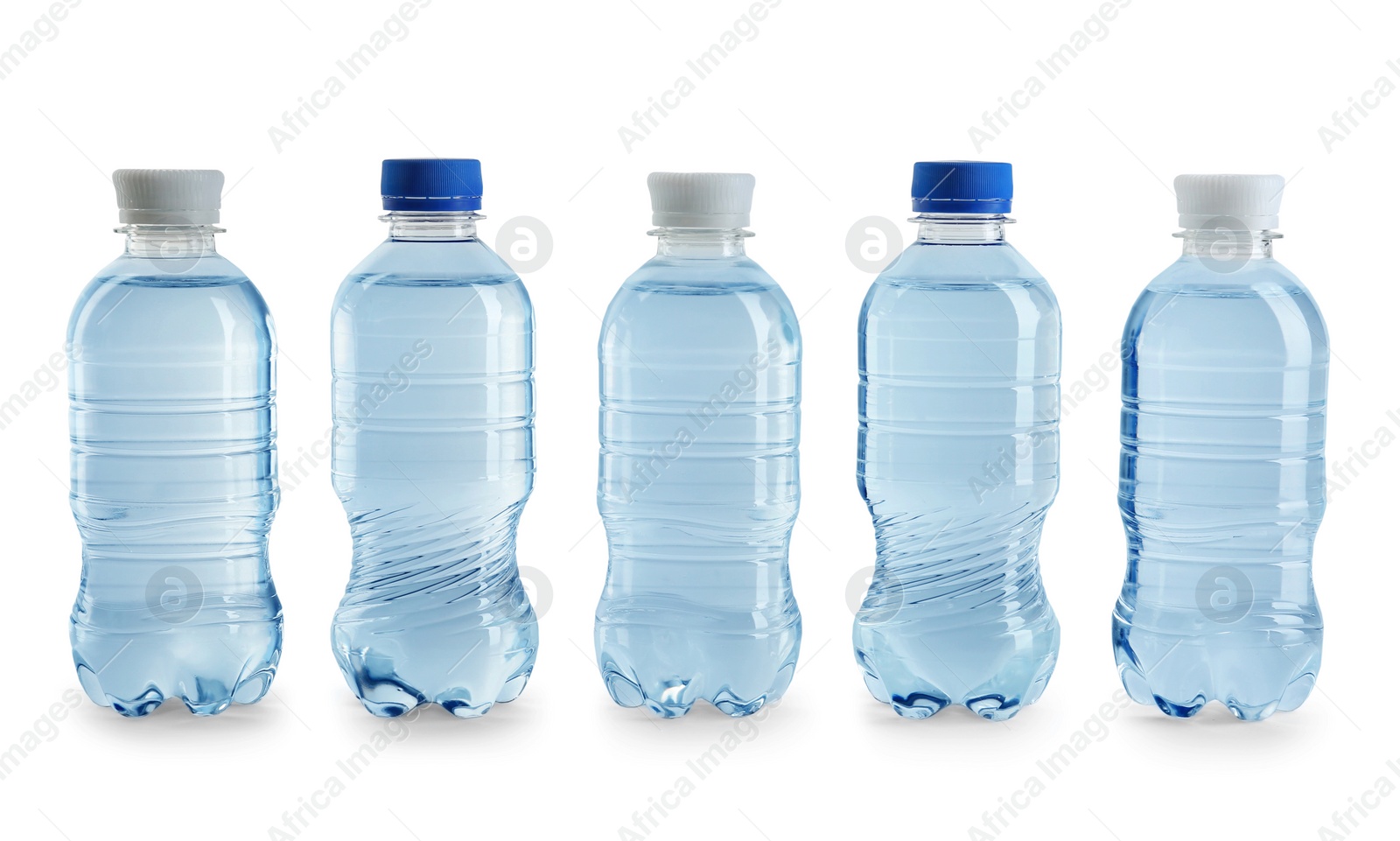 Photo of Row of different plastic bottles with water on white background