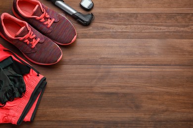 Photo of Flat lay composition with different cycling accessories on wooden background, space for text