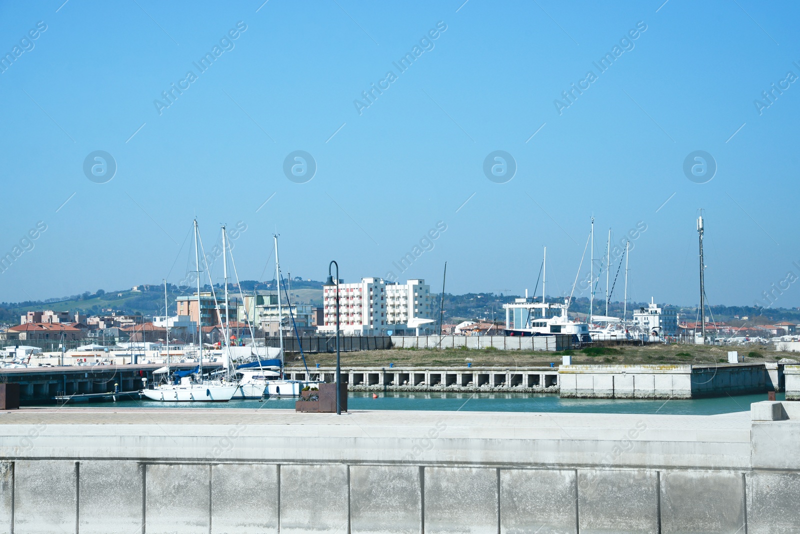 Photo of Beautiful view of city from pier with boats