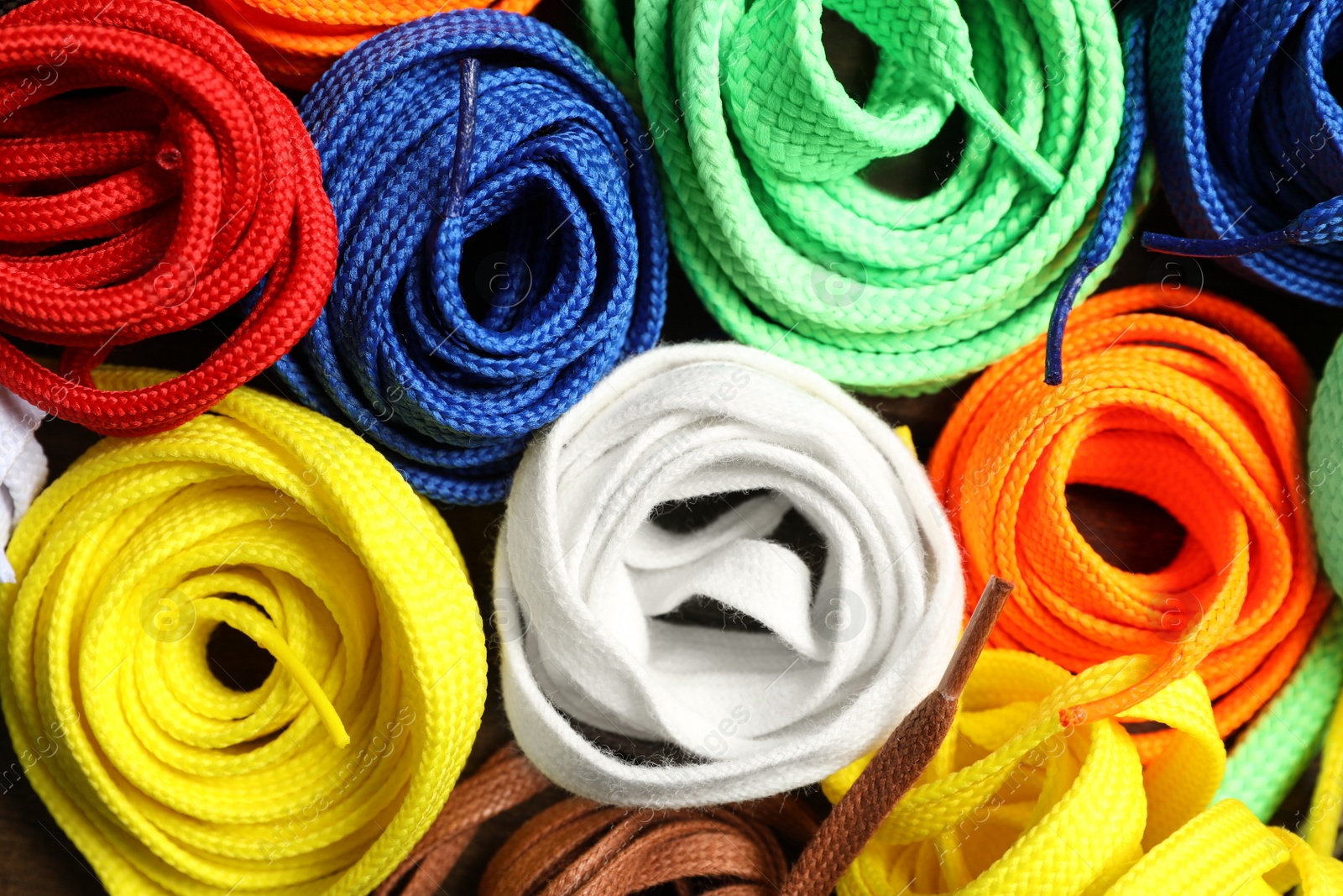 Photo of Colorful shoelaces as background, closeup. Stylish accessory