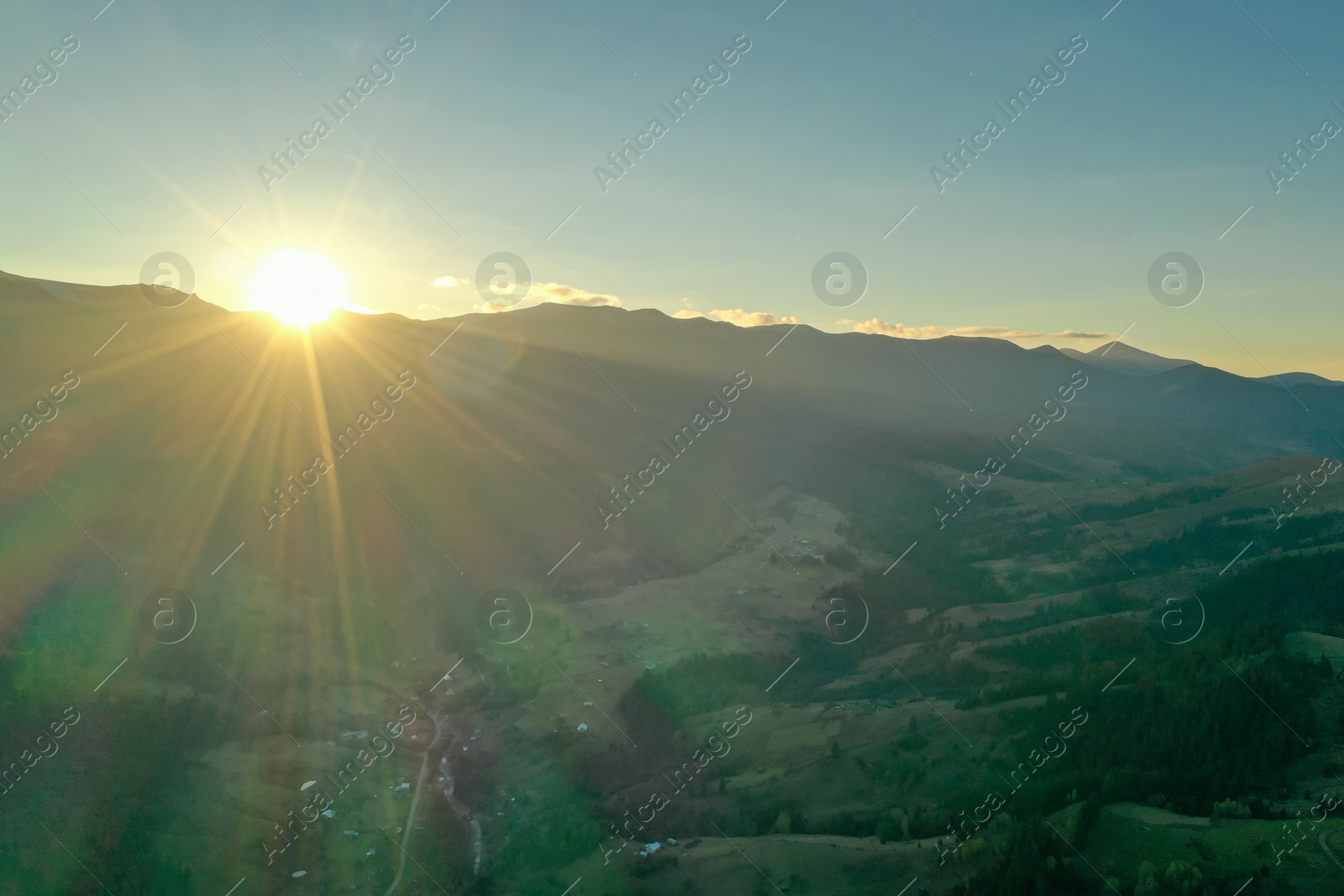 Photo of Aerial view of beautiful mountain landscape with village at sunrise