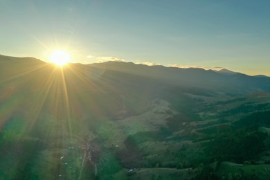 Photo of Aerial view of beautiful mountain landscape with village at sunrise