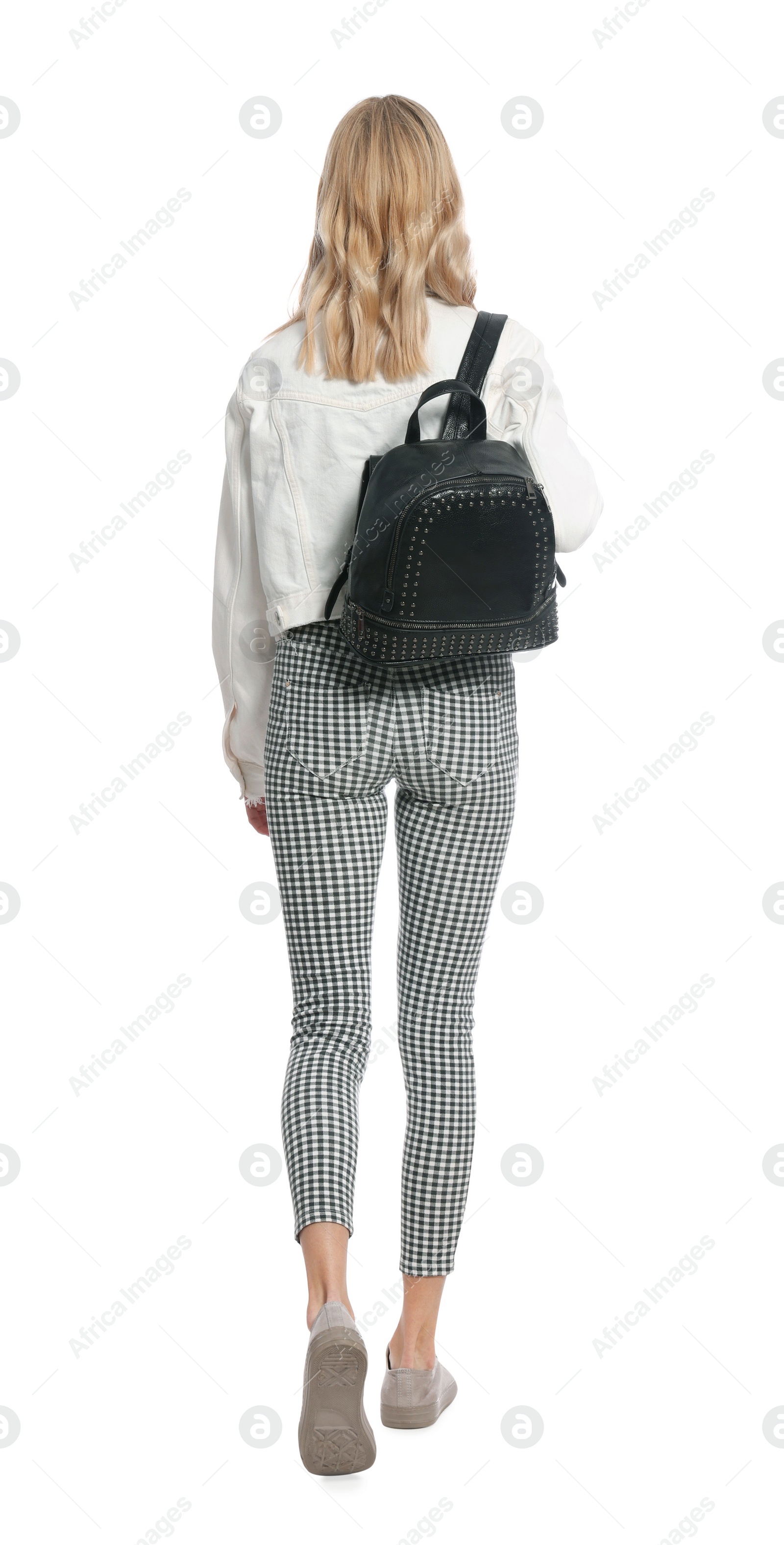 Photo of Young woman with black bag walking on white background, back view