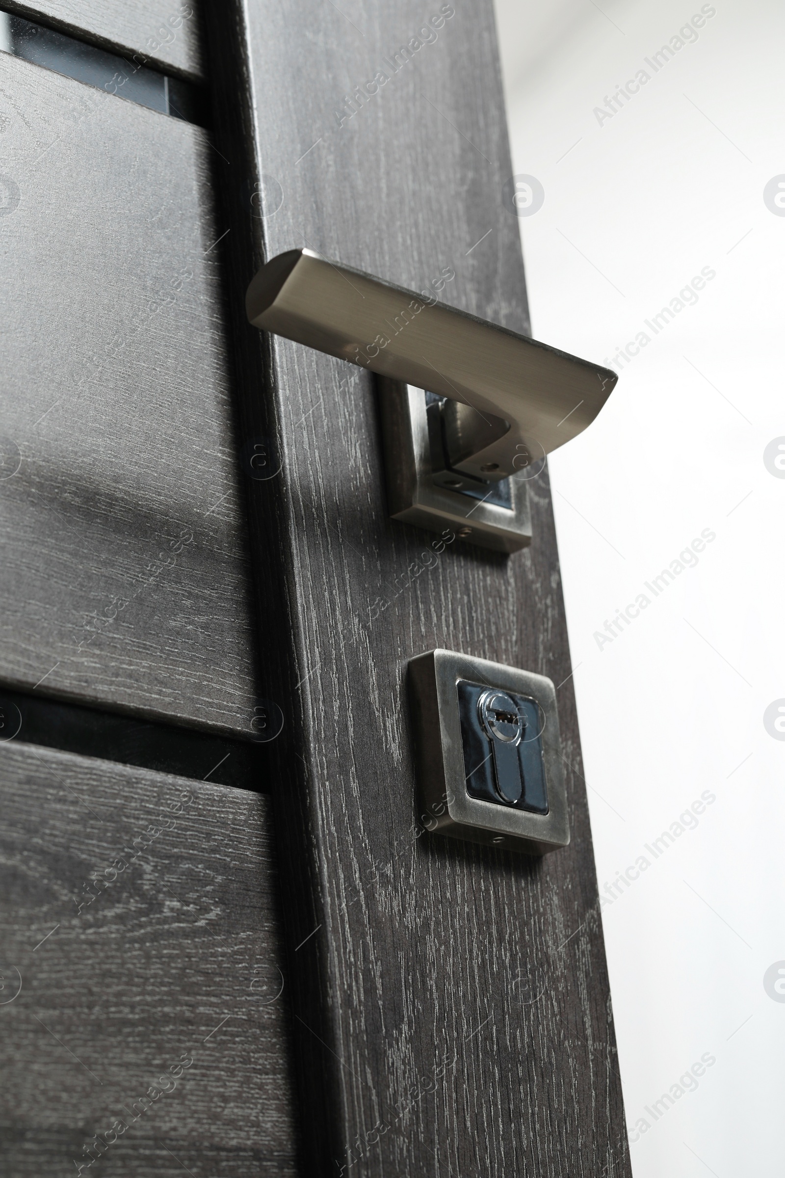 Photo of Open wooden door with metal handle, closeup