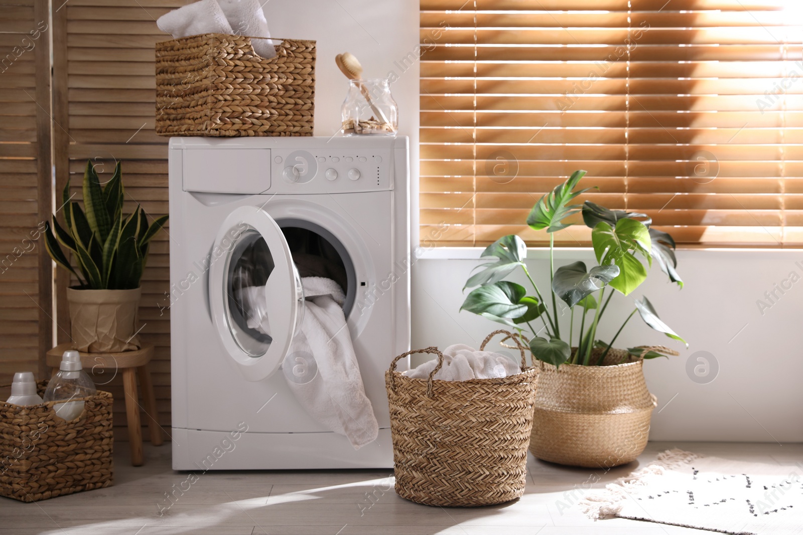 Photo of Stylish room interior with washing machine. Design idea