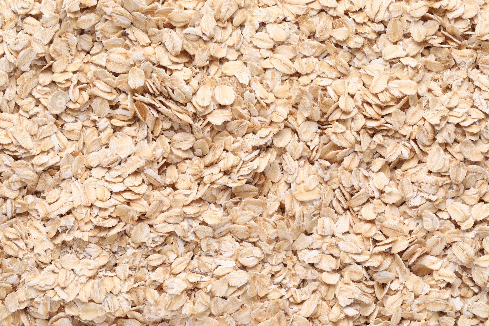 Photo of Top view of rolled oats as background