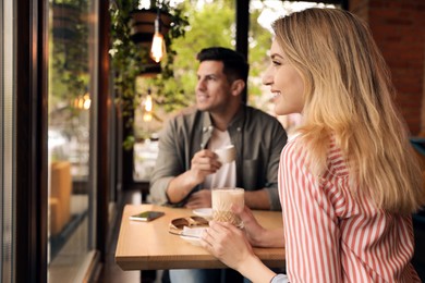 Lovely couple spending time at cafe in morning