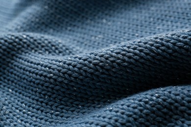 Photo of Beautiful pale blue knitted fabric as background, closeup