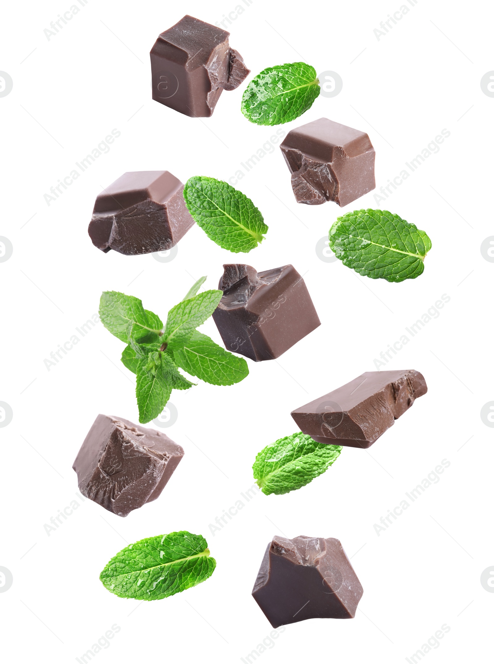 Image of Milk chocolate pieces and mint falling on white background