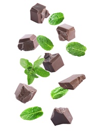 Image of Milk chocolate pieces and mint falling on white background