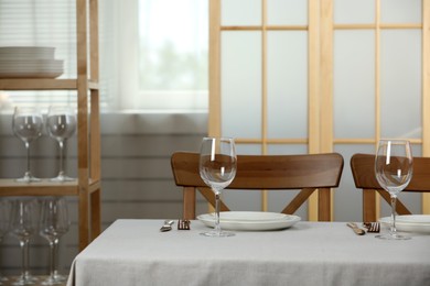 Table setting in dining room. Clean dishware