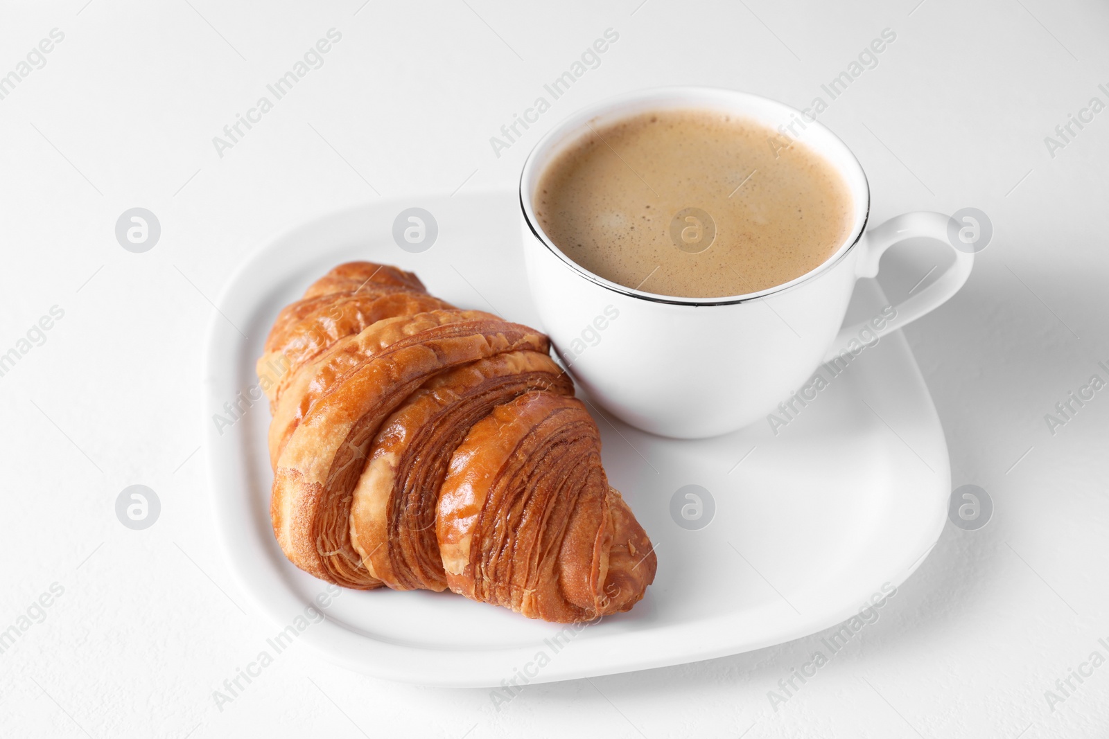 Photo of Fresh croissant and coffee on white background. Tasty breakfast