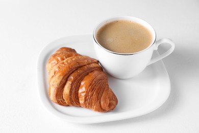 Photo of Fresh croissant and coffee on white background. Tasty breakfast