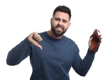 Upset man with empty wallet showing thumbs down on white background
