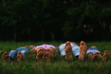 Happy family lying on grass in park