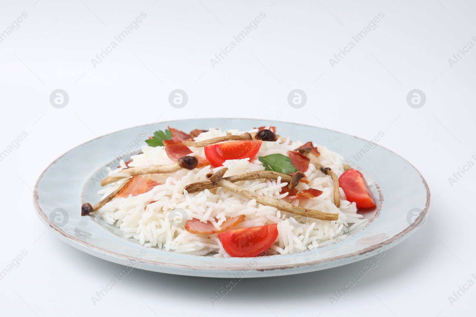 Photo of Delicious rice with bacon, mushrooms and tomatoes isolated on white