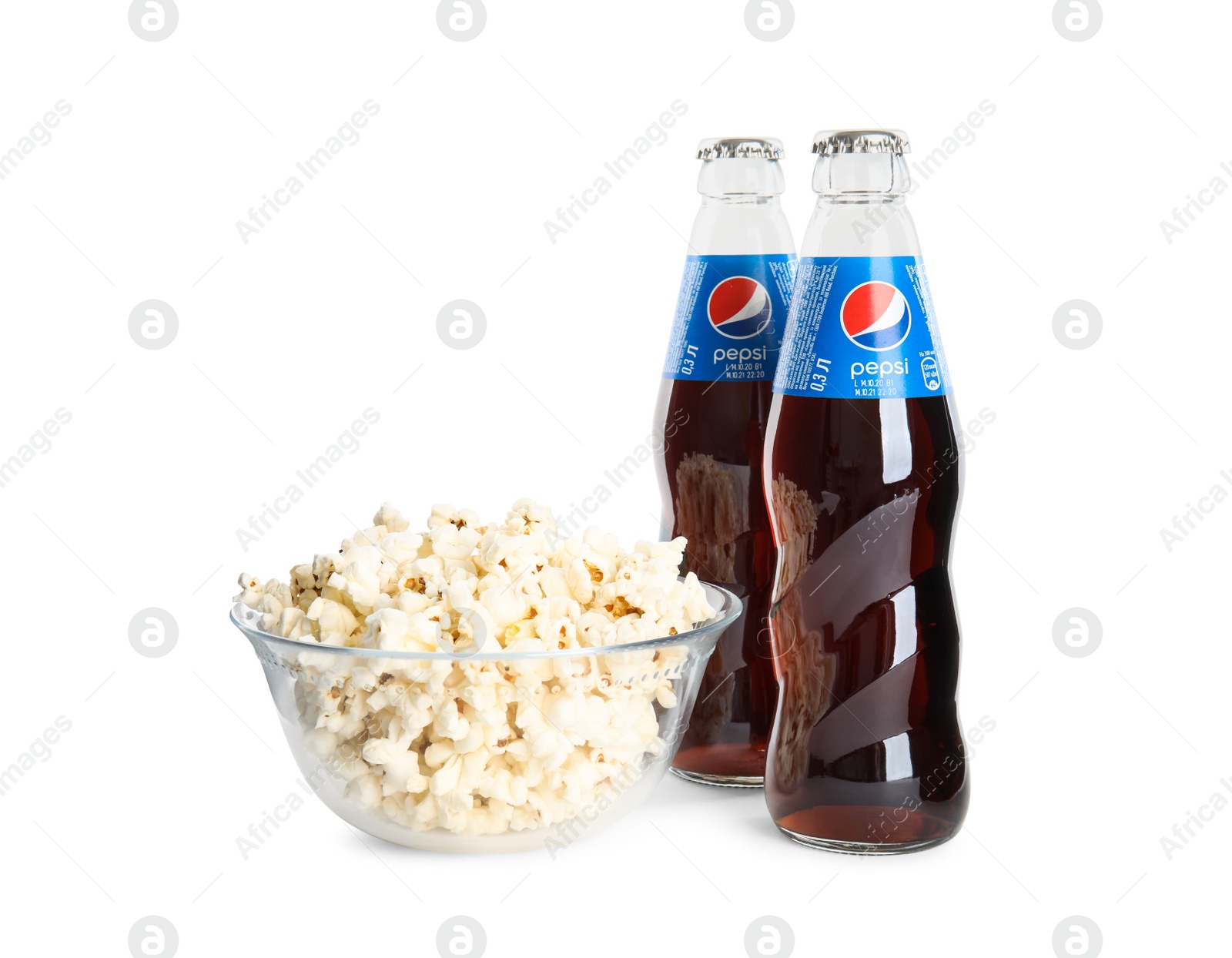 Photo of MYKOLAIV, UKRAINE - FEBRUARY 15, 2021: Glass bottles of Pepsi and snack on white background