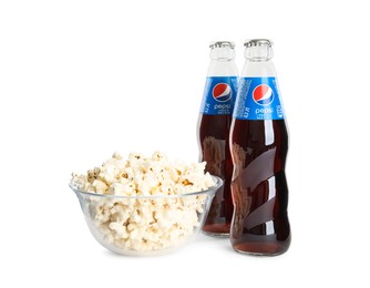 MYKOLAIV, UKRAINE - FEBRUARY 15, 2021: Glass bottles of Pepsi and snack on white background