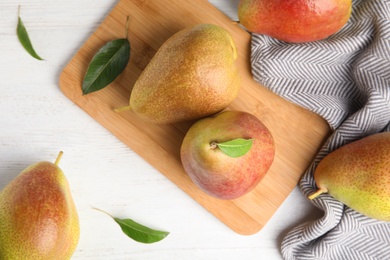 Photo of Ripe juicy pears on white wooden table, top view