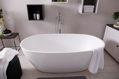 Photo of Stylish bathroom interior with modern white tub