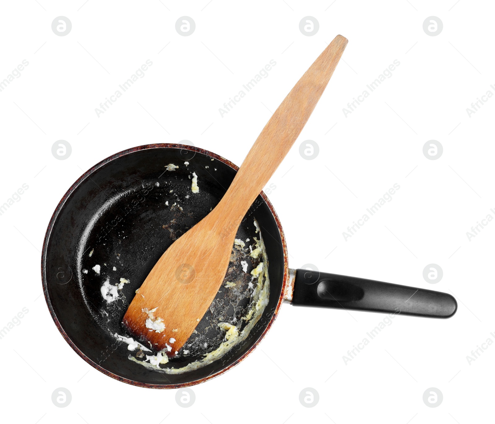 Photo of Dirty frying pan and wooden spatula on white background, top view