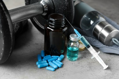 Photo of Different drugs and sports equipment on grey background. Doping control