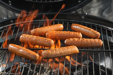 New modern barbecue grill with tasty sausages, closeup