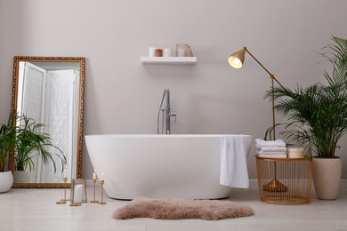 Photo of Stylish bathroom interior with modern white tub