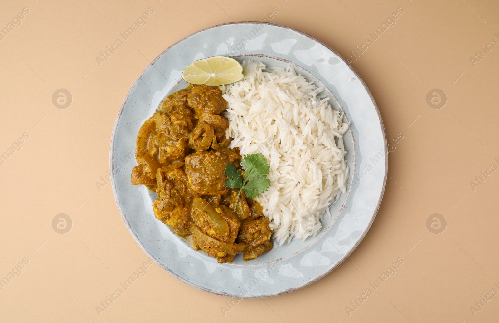 Photo of Delicious chicken curry with rice on beige background, top view