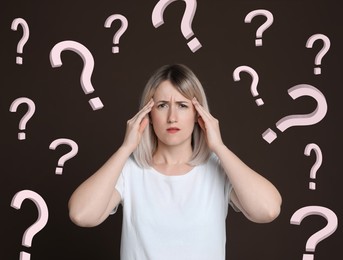 Image of Amnesia. Confused woman and question marks on brown background
