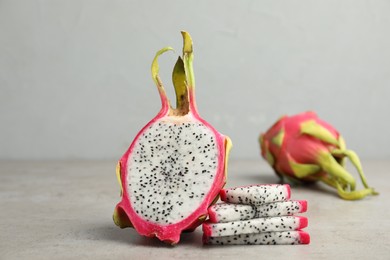 Delicious sliced dragon fruit (pitahaya) on grey table